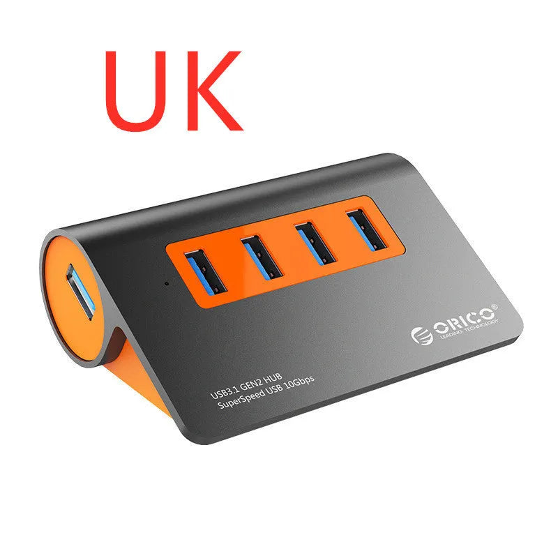 Dark grey and orange aluminium USB C hub with four USB 3.1 ports and a long black data cable.
