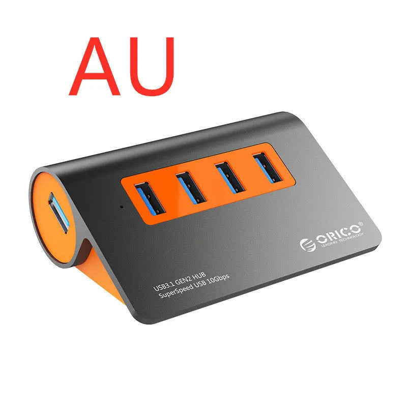 Dark grey and orange aluminium USB C hub with four USB 3.1 ports and a long black data cable.