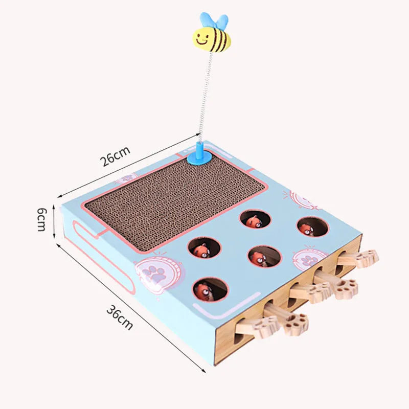 Blue cat toy teaser whack-a-mole game on floor, 36x26x6cm, cardboard and wood construction.