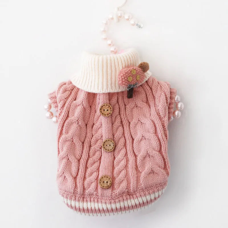 Classic knitted pet sweater in pink for small dogs, with twist button closure, on a white background