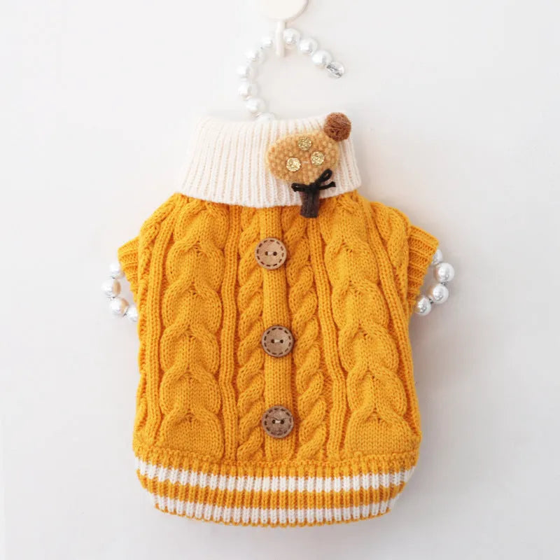 Classic knitted pet sweater in pink for small dogs, with twist button closure, on a white background