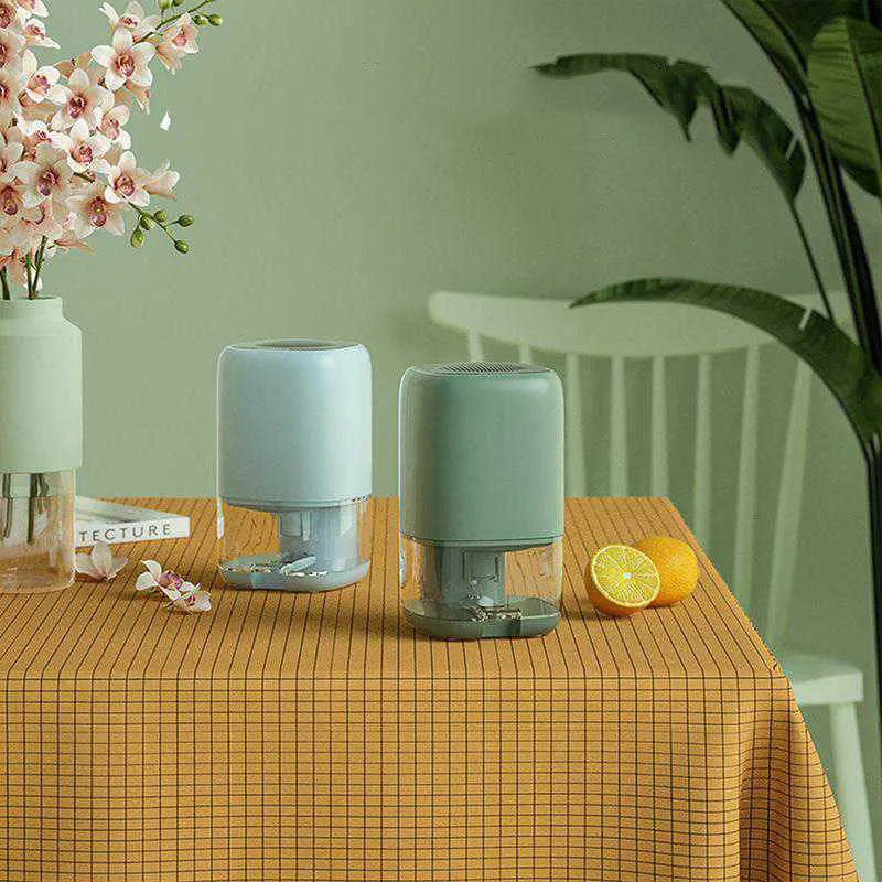 Portable white dehumidifier unit with a 0.7L water tank and UK power plug on a wooden floor.