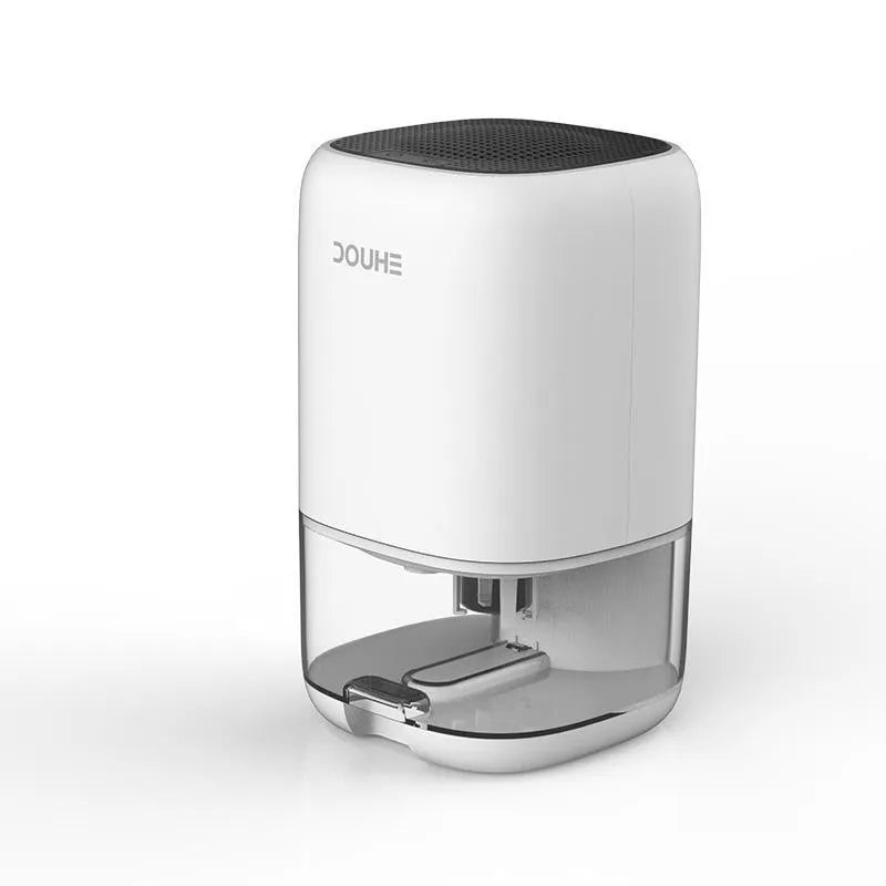 Portable white dehumidifier unit with a 0.7L water tank and UK power plug on a wooden floor.