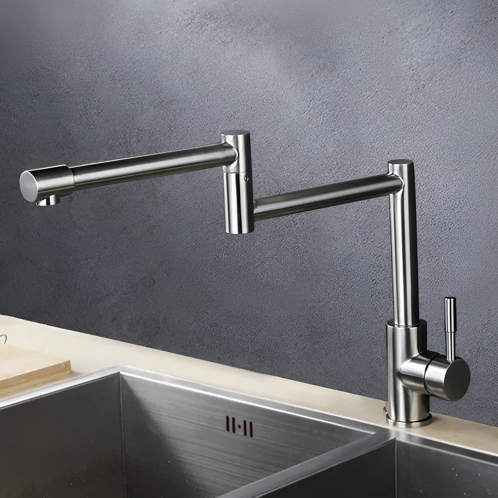 Silver stainless steel kitchen mixer tap with dual lever controls and rotating spout
