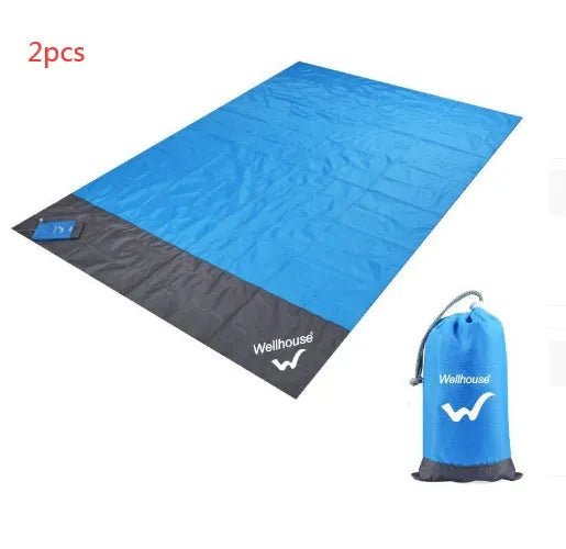 Blue and grey waterproof camping mat 2m x 2.1m with TPU coating, pegs, and storage sack on grass