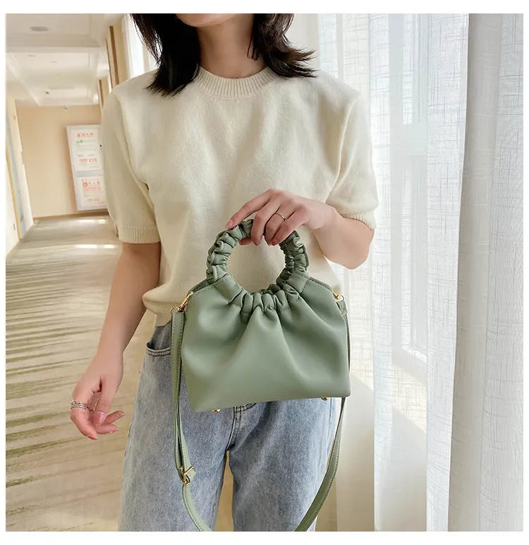 Medium one-shoulder bucket messenger bag in soft PU with fold detail and internal phone pocket