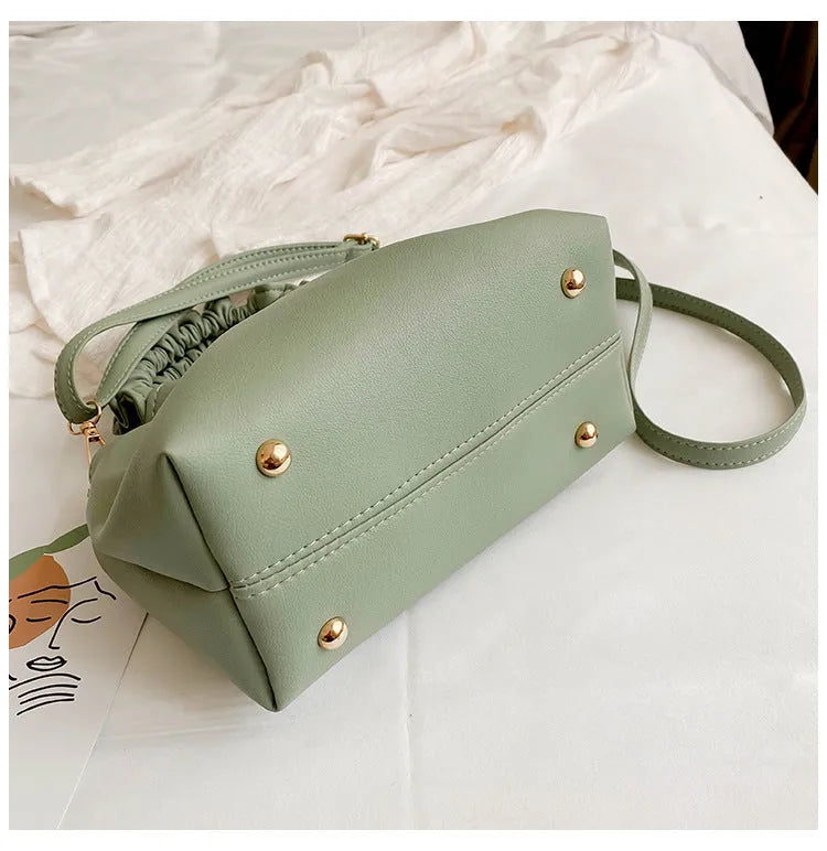 Medium one-shoulder bucket messenger bag in soft PU with fold detail and internal phone pocket