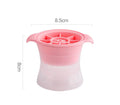 Flexible silicone ice tray showing large hockey puck and spherical ice cube moulds in pastel colours.