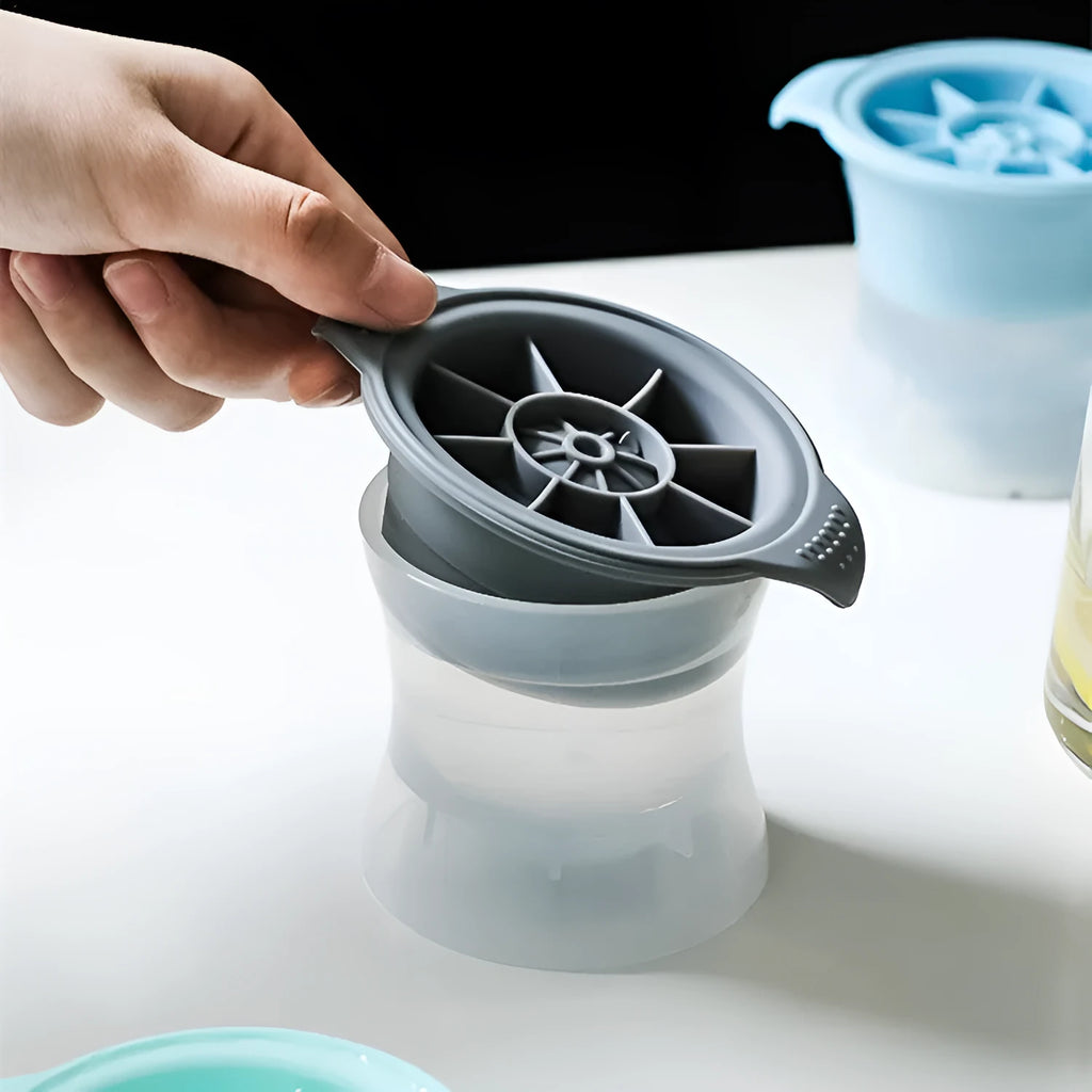 Flexible silicone ice tray showing large hockey puck and spherical ice cube moulds in pastel colours.
