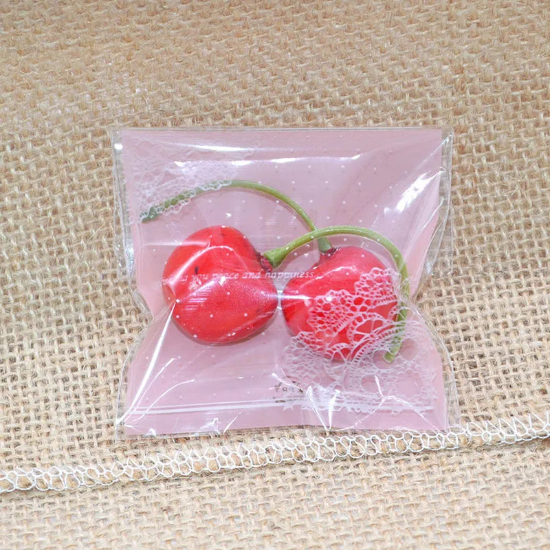 Pink self-adhesive plastic packaging bags with UV printing, shown sealed and open, next to a bar of soap.