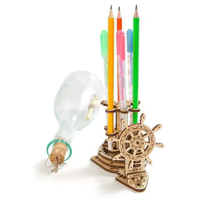 Ukrainian wooden machinery model pen holder with rotating base and four slots for pens on a desk.