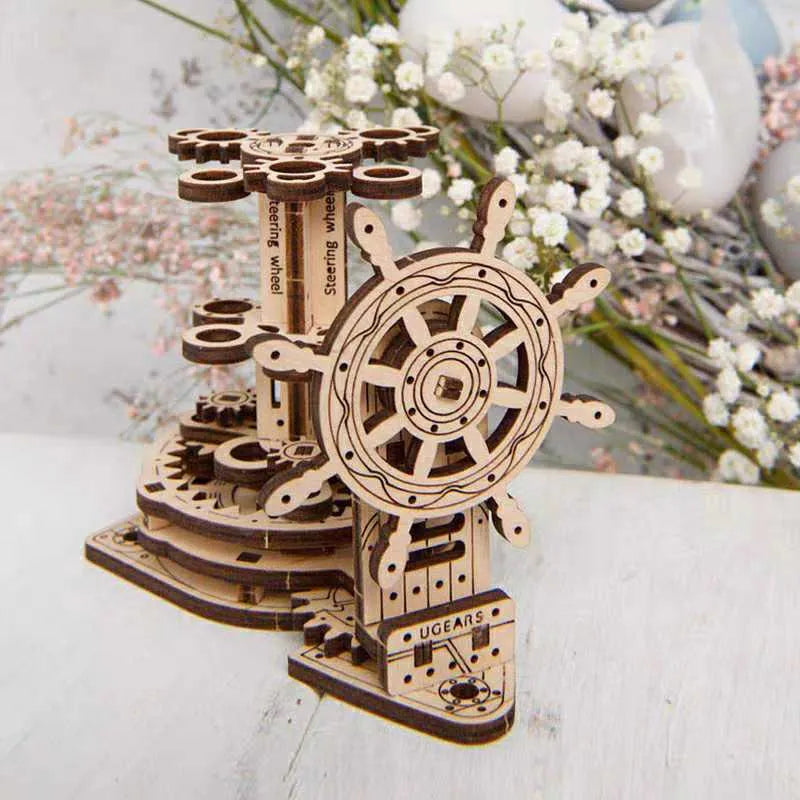 Ukrainian wooden machinery model pen holder with rotating base and four slots for pens on a desk.