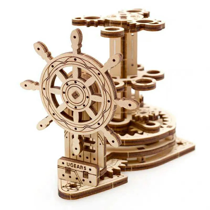 Ukrainian wooden machinery model pen holder with rotating base and four slots for pens on a desk.