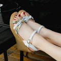 Women's pink wedge heel sandals with a buckle closure and textured non-slip sole on a white background.