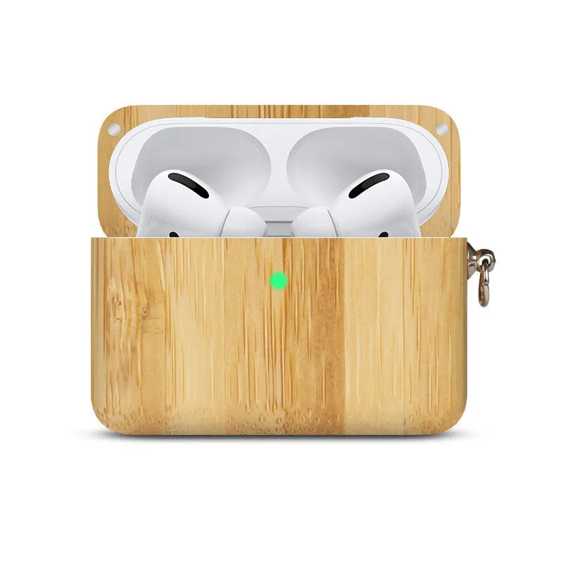 Solid walnut and bamboo wood sleeves for Bluetooth earphones on a wooden table.