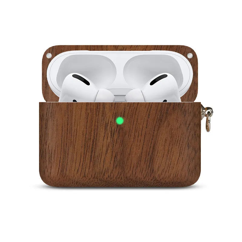 Solid walnut and bamboo wood sleeves for Bluetooth earphones on a wooden table.