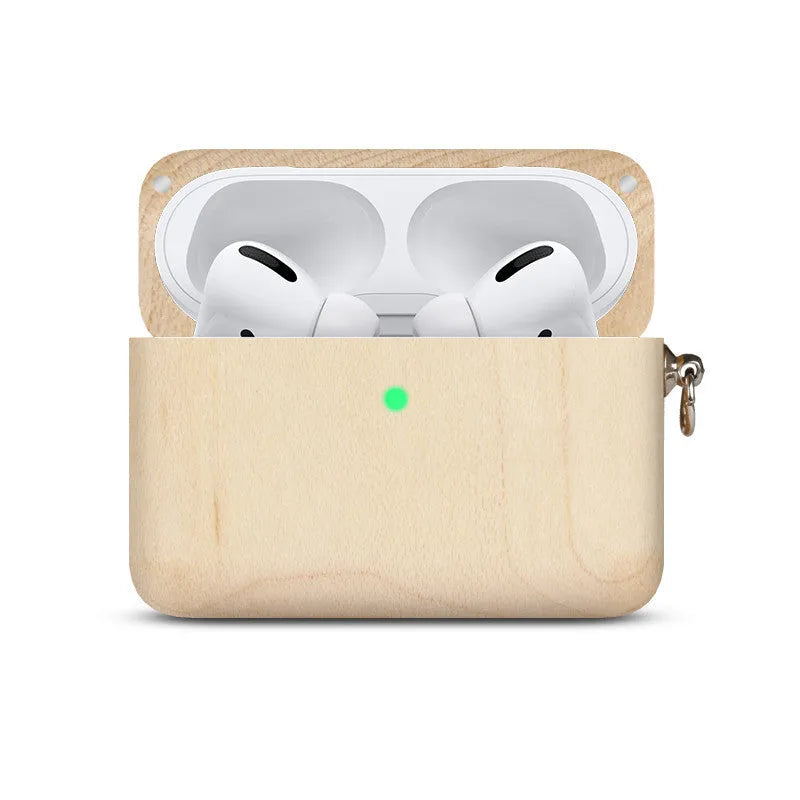 Solid walnut and bamboo wood sleeves for Bluetooth earphones on a wooden table.