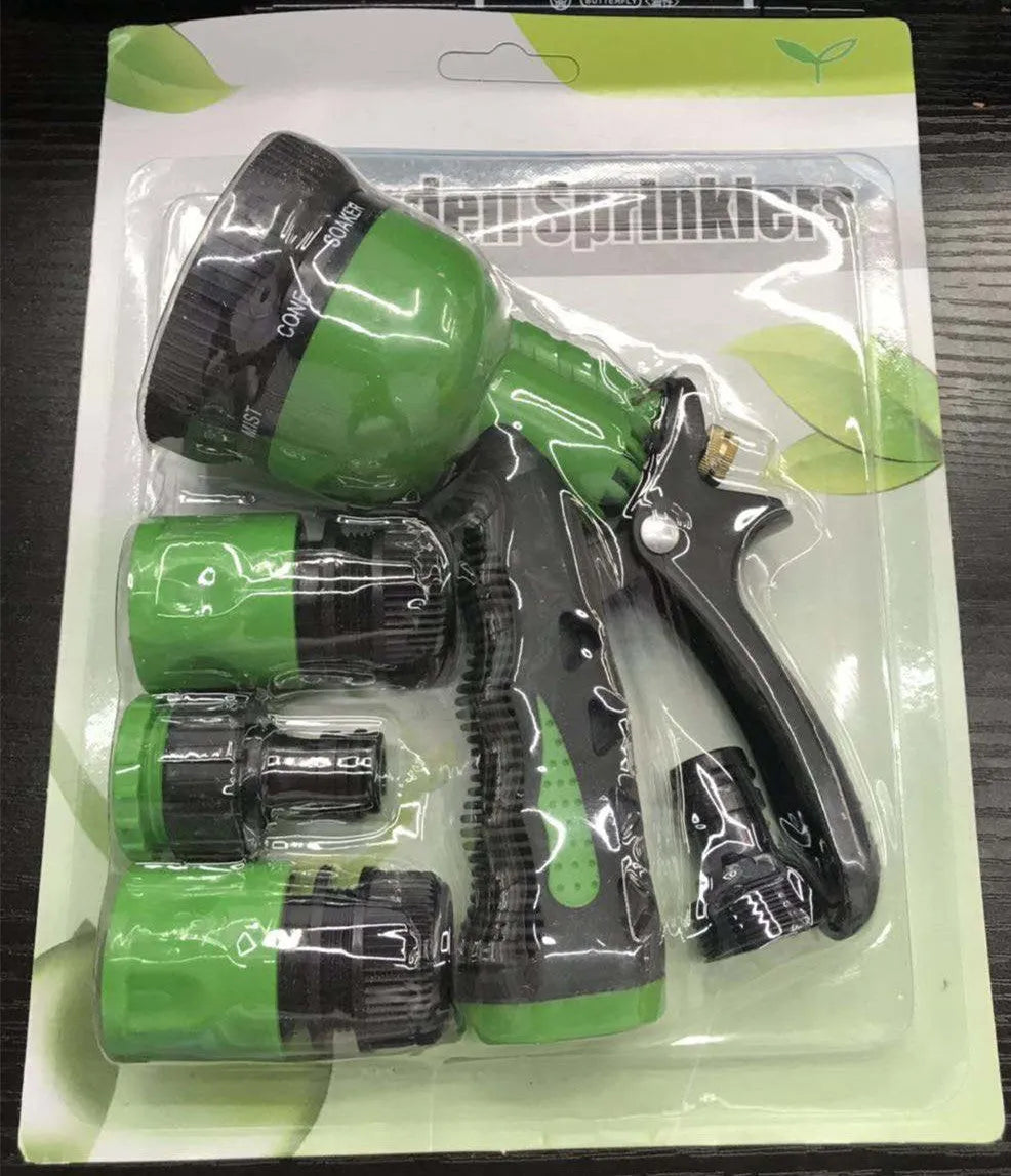 All metal garden spray gun with zinc alloy build and green handle held near potted plants