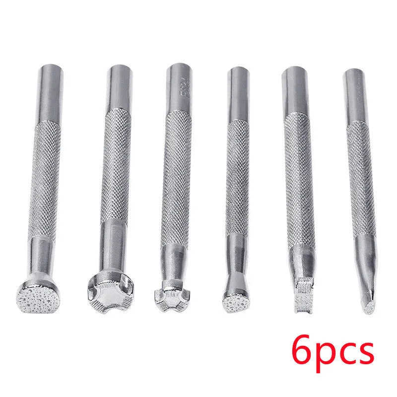 Set of six alloy leather carving printing sticks arranged on a workbench, tools for stamping and embossing