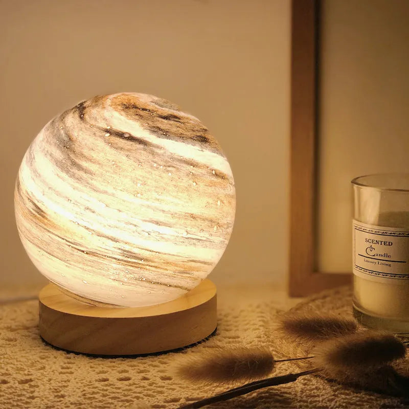 Girl Heart Nordic style glass table lamp in chosen colour with USB cable and button switch on bedside table.