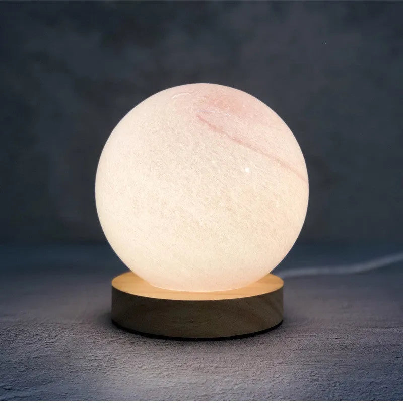 Girl Heart Nordic style glass table lamp in chosen colour with USB cable and button switch on bedside table.