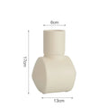 Nordic style hammer-shaped ceramic vase in colour glaze finish on a wooden cabinet.