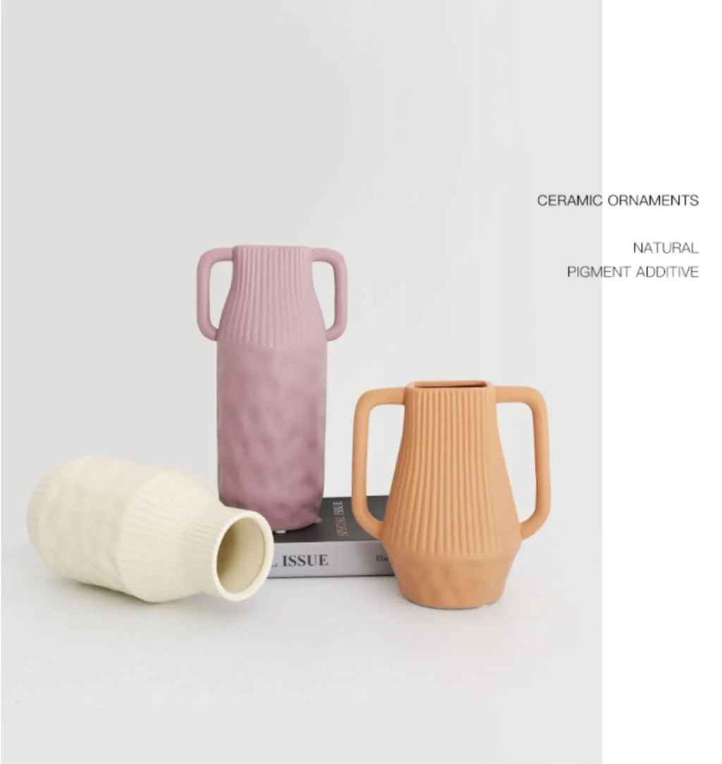 White ceramic hammer-shaped vase with Morandi colour glaze in beige, on a wooden surface.