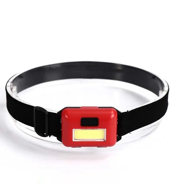 Compact blue, black, or red LED headlamp with a polyester head strap, showing 3W COB bulb.