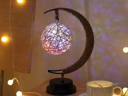 Warm white dimmable LED modelling light in apple shape with 10 beads on a wooden table