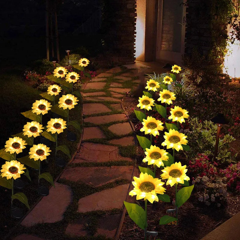 LED solar sunflower lamp with yellow fabric flower head, 66cm stainless steel stem, and ABS ground plug, placed on grass