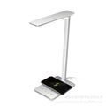 Black wireless charging LED desk lamp with touch control on a wooden desk