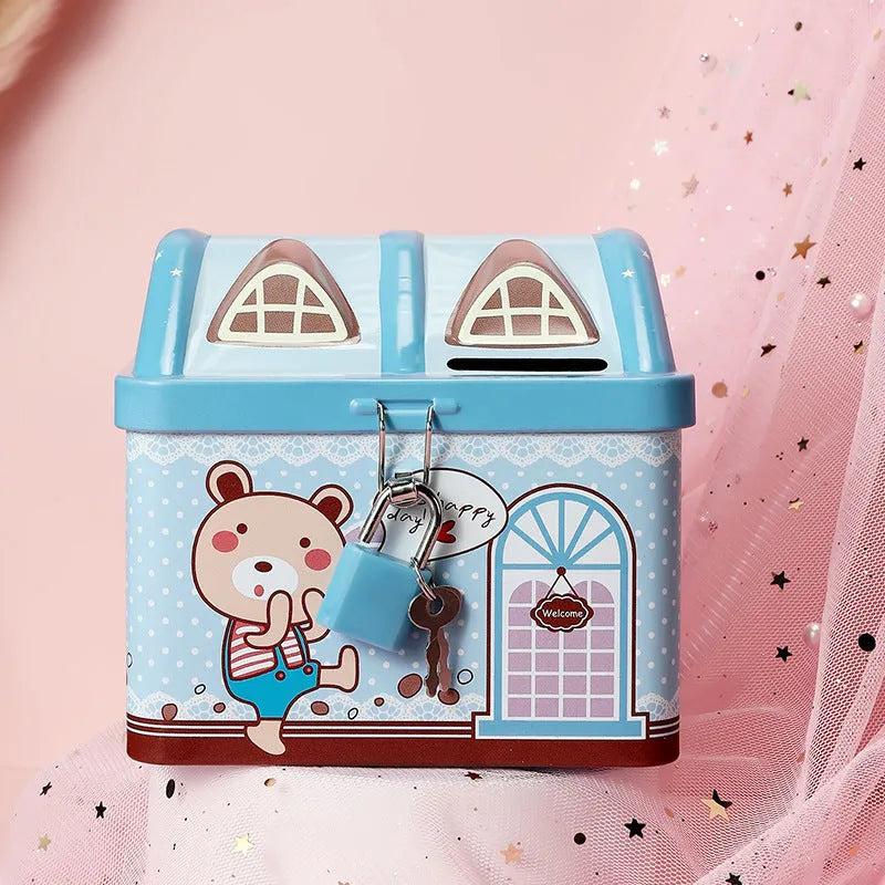 Blue house-shaped tinplate piggy bank with coin slot on desktop