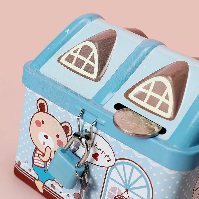 Blue house-shaped tinplate piggy bank with coin slot on desktop