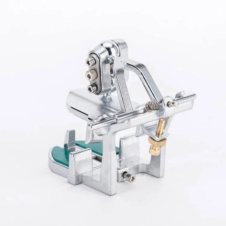 Korean-style adjustable dental articulator with incisal pins on a workbench.