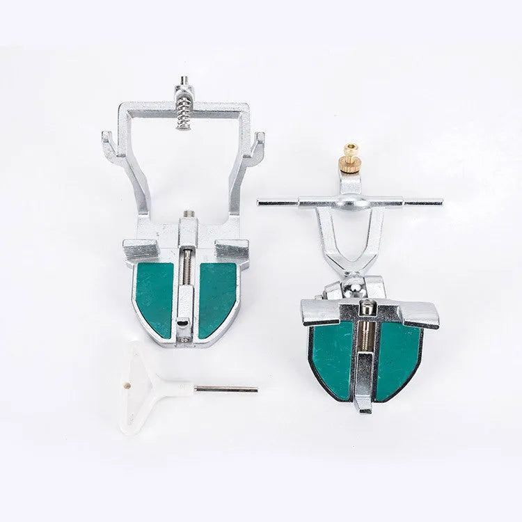 Korean-style adjustable dental articulator with incisal pins on a workbench.