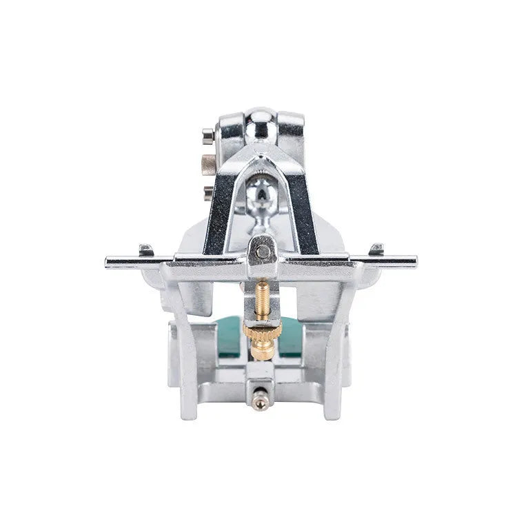 Korean-style adjustable dental articulator with incisal pins on a workbench.