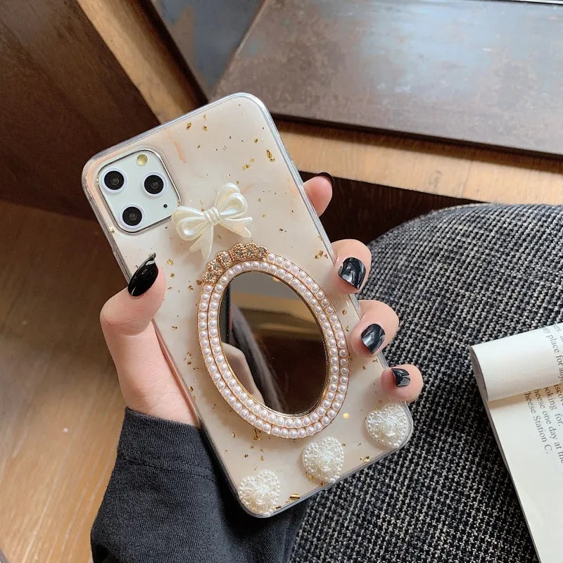 Brown marble pattern silicone iPhone case with rhinestone bowknot and a small circular mirror.