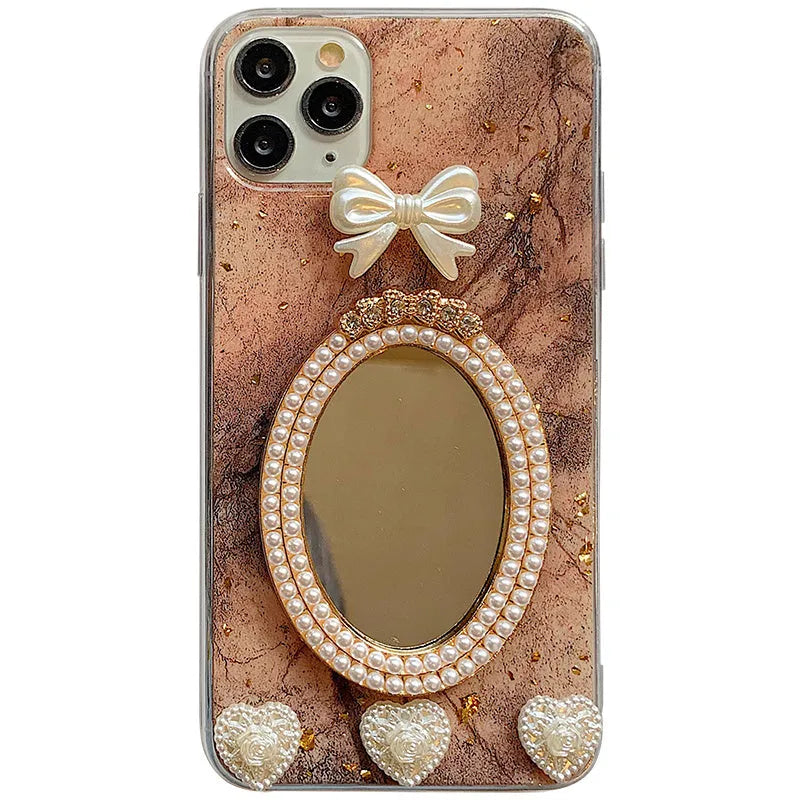 Brown marble pattern silicone iPhone case with rhinestone bowknot and a small circular mirror.