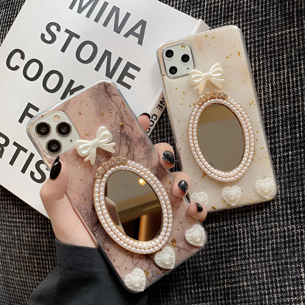 Brown marble pattern silicone iPhone case with rhinestone bowknot and a small circular mirror.