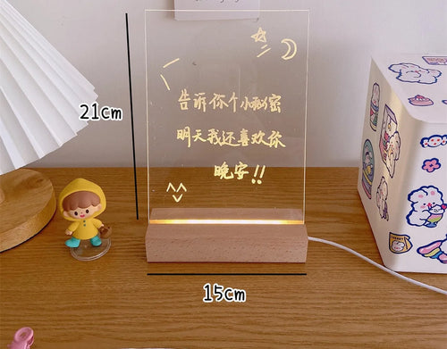 LED bedside night light with an optional erasable message board on a nightstand.