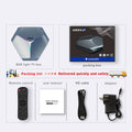 Android TV set-top box with remote control, HD cable, and power adapter on a table.