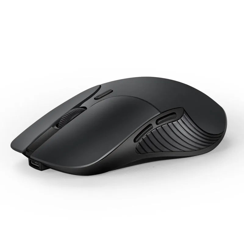Blue wireless Smart Voice Mouse with voice control button on a desk next to a laptop.