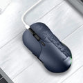 Blue wireless Smart Voice Mouse with voice control button on a desk next to a laptop.