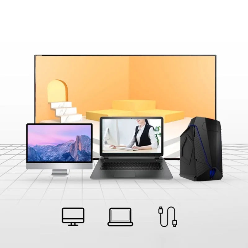 Blue wireless Smart Voice Mouse with voice control button on a desk next to a laptop.