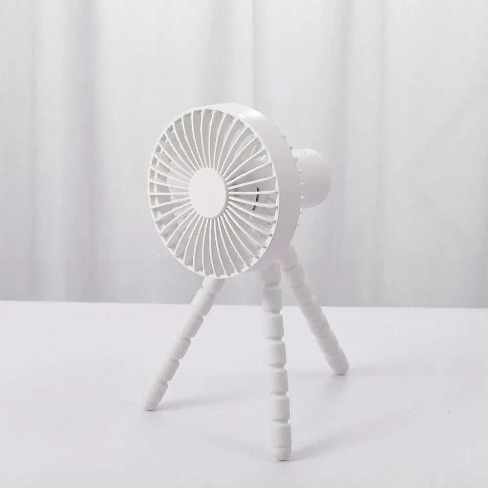USB-powered portable desk fan with flexible tripod legs and a removable front cover, shown in white.