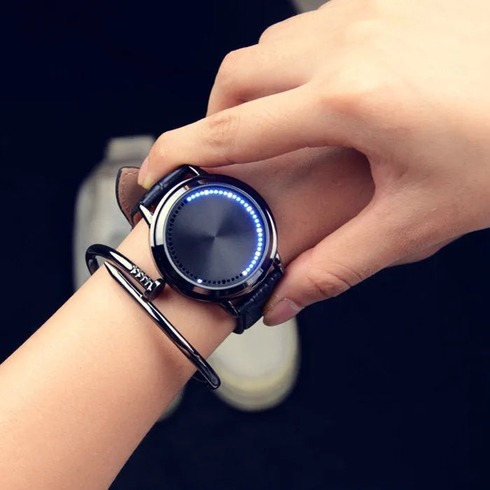 Electronic digital watch with blue light display on a black strap.