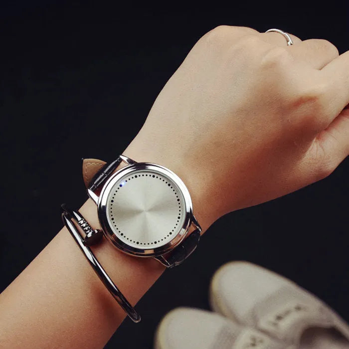 Electronic digital watch with blue light display on a black strap.