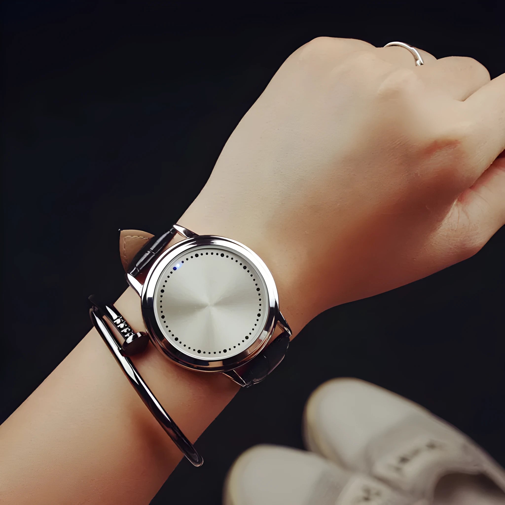 Electronic digital watch with blue light display on a black strap.