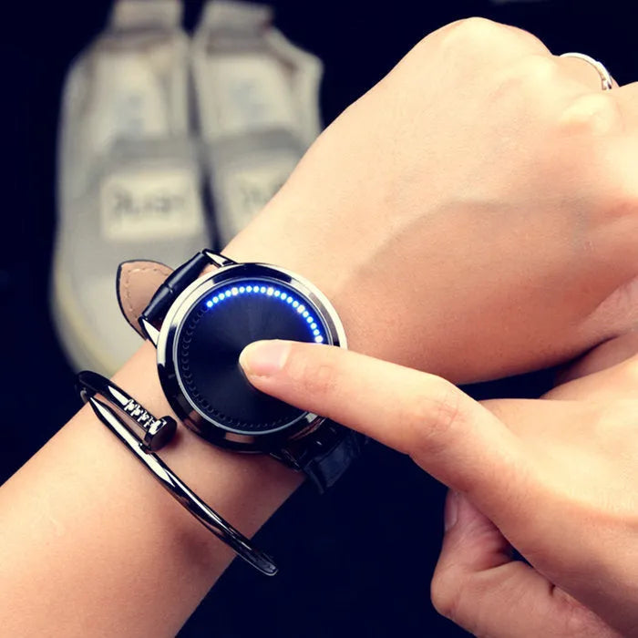 Electronic digital watch with blue light display on a black strap.