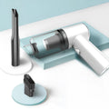 Handheld wireless car vacuum cleaner in black or white on a car seat.